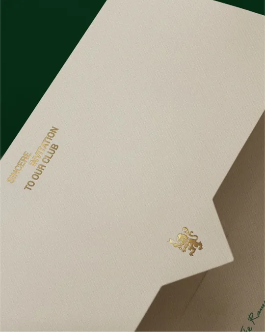 A Rampant Club invitation, the gold lion on cream